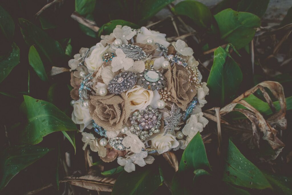 flat lay photography of white, brown, and silver flower bouquet