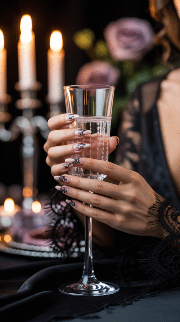 Nude nails with black lace nail art, styled for a gothic Halloween wedding guest look.